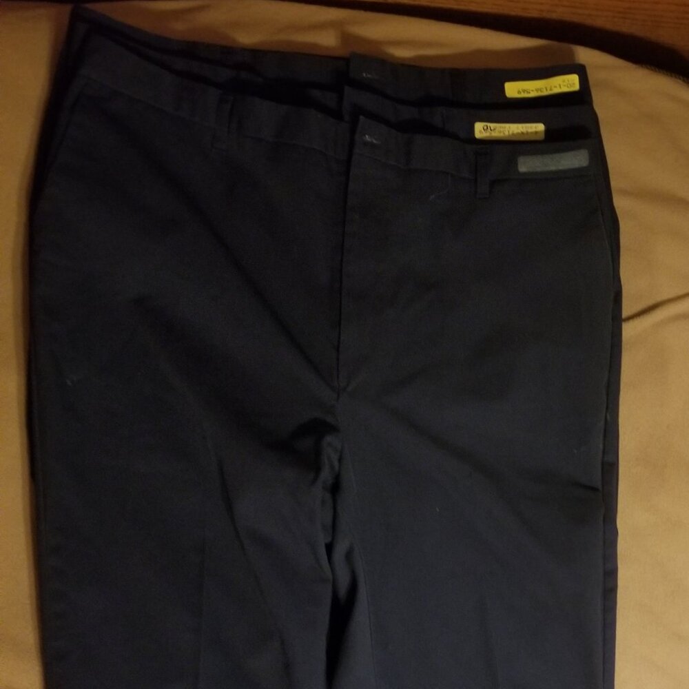 Three Cintas men's pants with small flaws